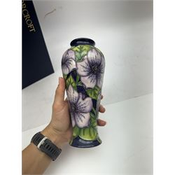 Moorcroft vase in Petunia pattern upon a purple ground, of tall baluster form, marked made for collectables to the base,  with original box, H21cm