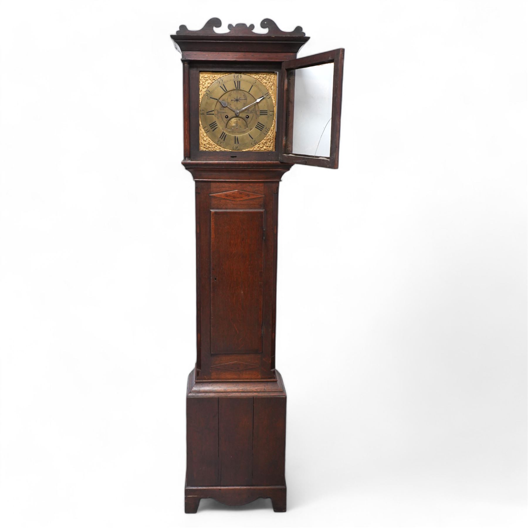 Benjamin Anns of Highworth (Wiltshire) - 8-day oak cased longcase clock c 1760 with a shaped pediment and square hood door beneath flanked by two pilasters with brass capitals, trunk with canted corners and a long flat topped door, on a rectangular plinth with applied decorative  skirting,  brass dial with an engraved dial centre, seconds dial, calendar aperture and steel spade hands, silvered chapter with Roman numerals and five minute Arabic's, dial pinned directly to a rack striking movement, striking the hours on a bell. With weights and pendulum.  