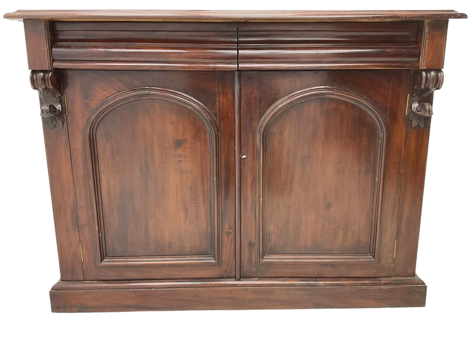 Victorian mahogany chiffonier, raised shaped back with foliage scroll carved mounts, on fretwork and carved bracket supports, moulded rectangular top over two frieze drawers and double panelled cupboard, on moulded plinth base