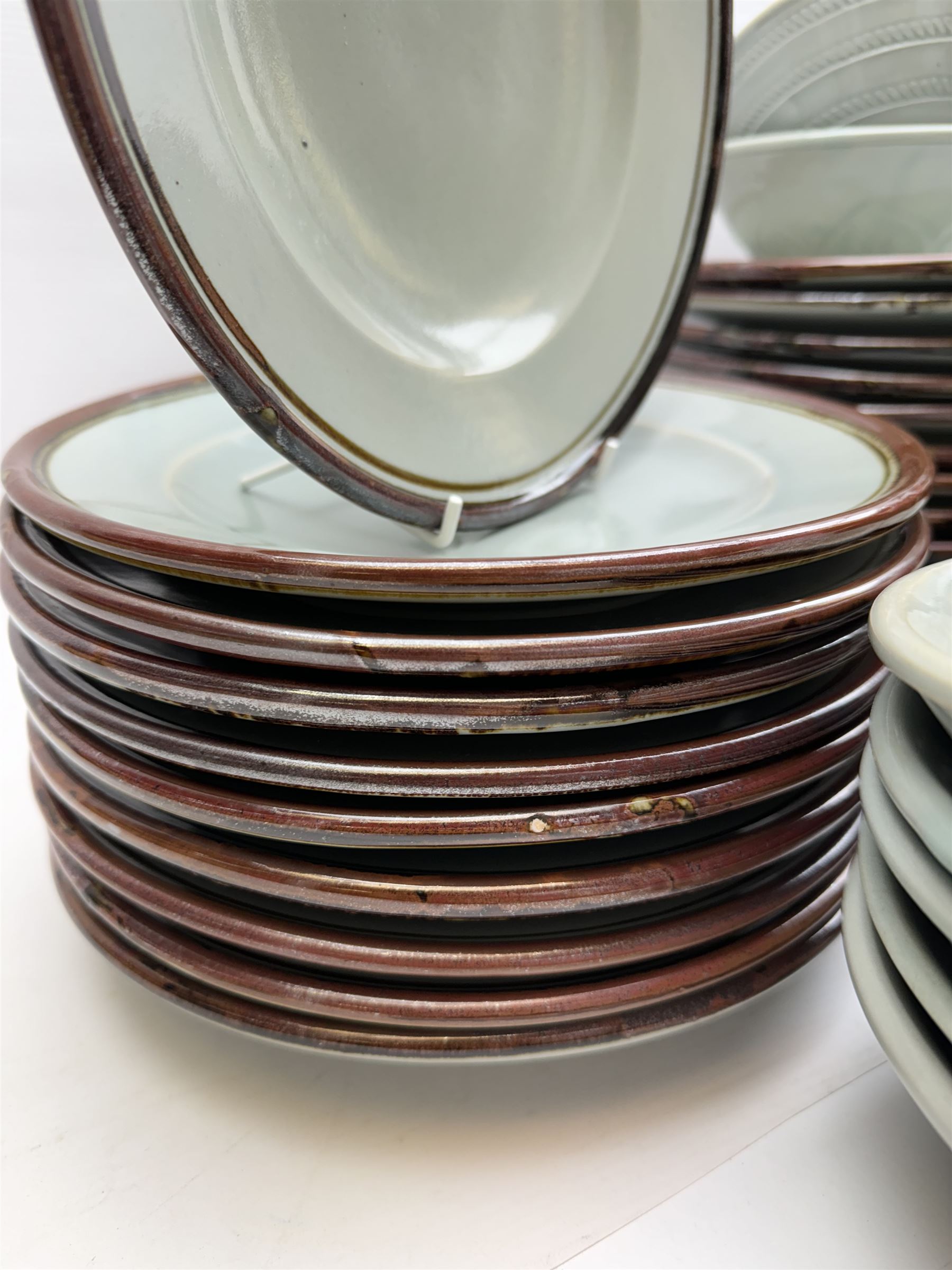 20th century celadon dinner service with iron rim, comprising nineteen dinner plates 26.5cm, twenty-four side plates D24cm, twelve varying bowls, twenty-two tea plates and fifteen saucers 