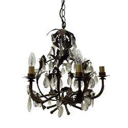 Early 20th century wrought metal chandelier, of scrolled form with six branches, decorated with leafage and glass pendants 