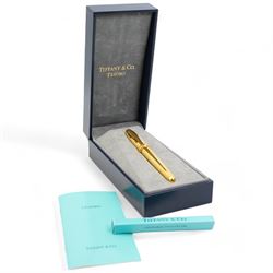 Tiffany & Co. Tesoro gilt rollerball pen, boxed with papers with rollerball refill