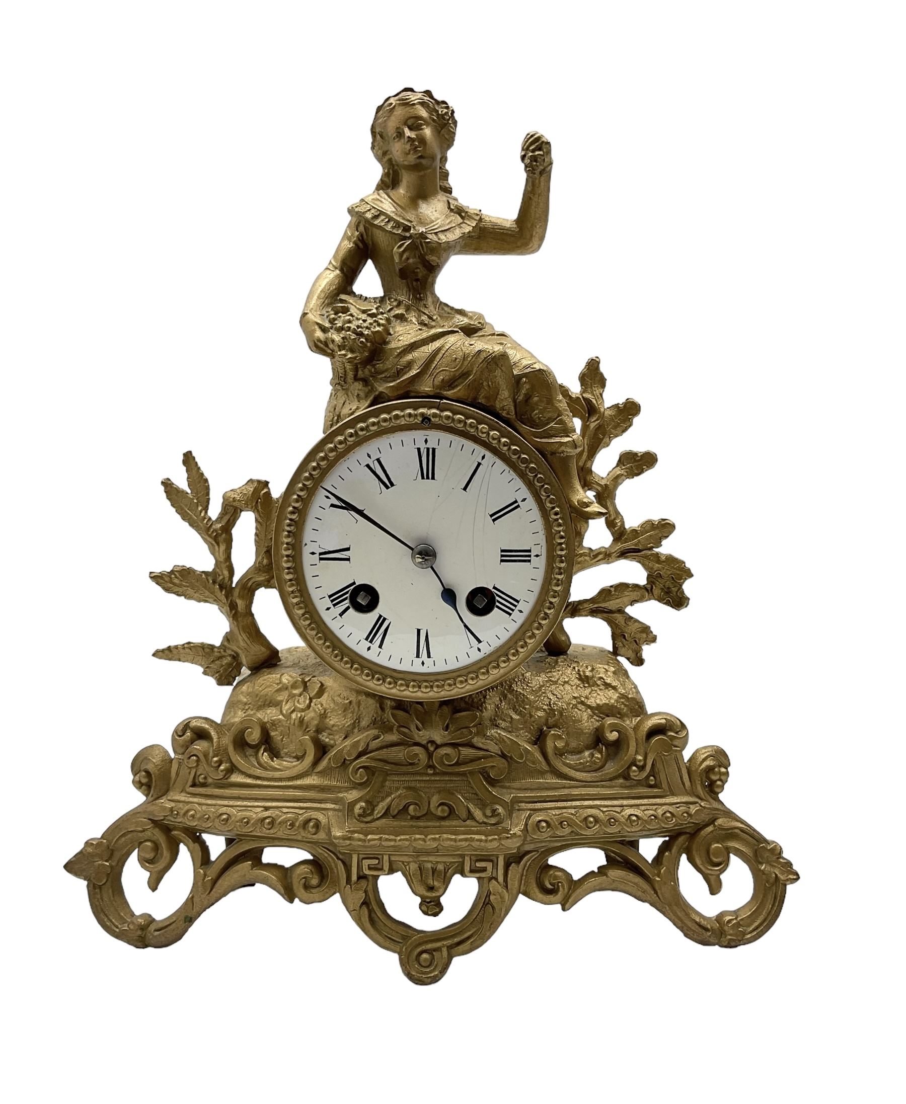 French - late 19th century 8-day mantle clock, in a spelter case with a solitary maiden seated above the drum movement, with an enamel dial, Roman numerals, minute markers and spade hands, twin train countwheel striking movement striking the hours and half hours on a bell. With pendulum and key. 