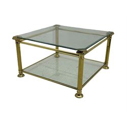 Mid 20th century brass and glass coffee table, square glass top with bevelled edges over undertier, supported by brass columns joined by crossbars, on circular feet