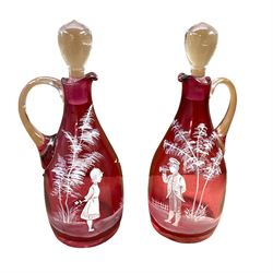 Pair of cranberry glass ewers with stoppers, with Mary Gregory style decoration, H28.5cm