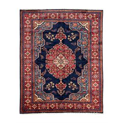 Persian Veis indigo ground carpet, the field with large pole medallion decorated with Hera...