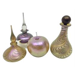 Four Okra scent bottles, the first example modelled as an apple, the second of squat form decorated with iridescent threads upon a gold ground and two others 