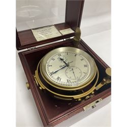 Two-day marine chronometer, with silvered dial inscribed Thomas Mercer Ltd, St Albans, contained within a brass gimbal-mounted bowl and glazed mahogany case, with applied brass plaque reading 'supplied by Kelvin Hughes no. 24295', brass winding key and two service notes to interior of case, dial D12cm, wooden case H17.5cm 