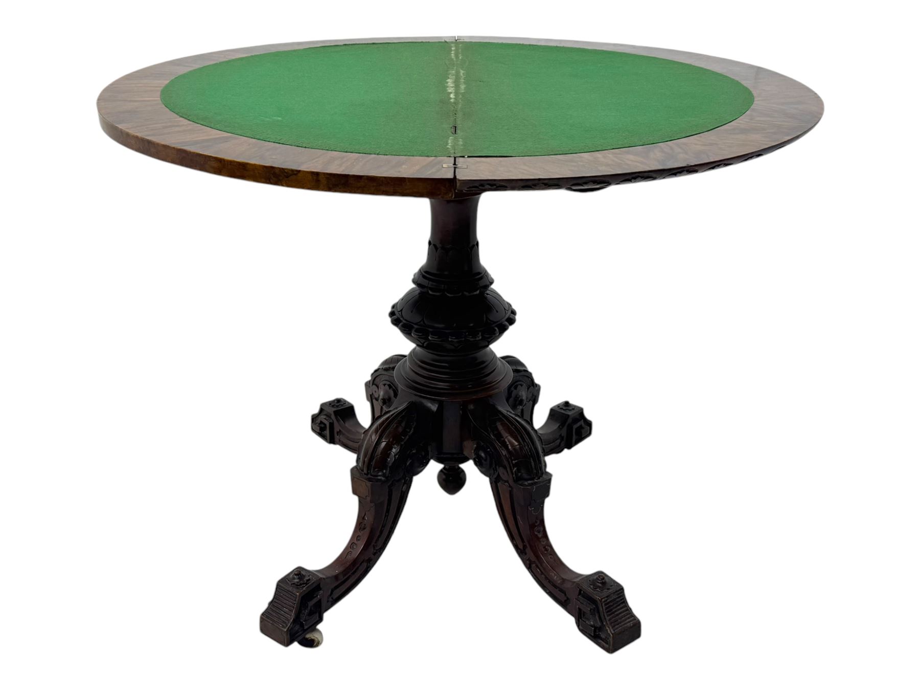 Victorian walnut demi-lune card table, circular fold-over top with foliate carved edge, revealing green baize-lined playing surface over scalloped apron, raised on a turned and carved pedestal with four splayed scroll supports with castors