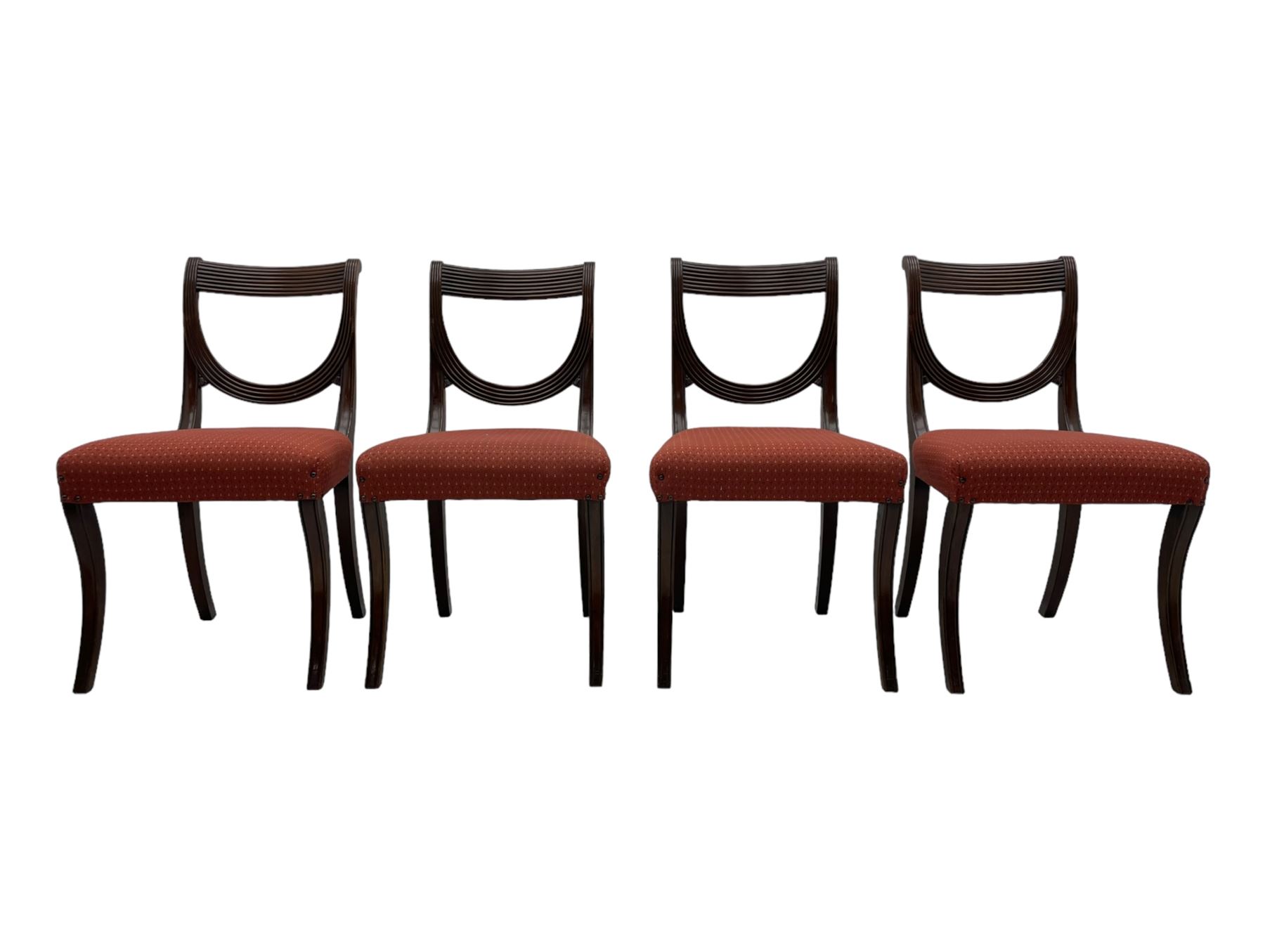 Set of six (4+2) George III design mahogany dining chairs, curved reed moulded bar back over curved and reeded middle rail, upholstered in red fabric with repeating pattern, on moulded sabre supports 