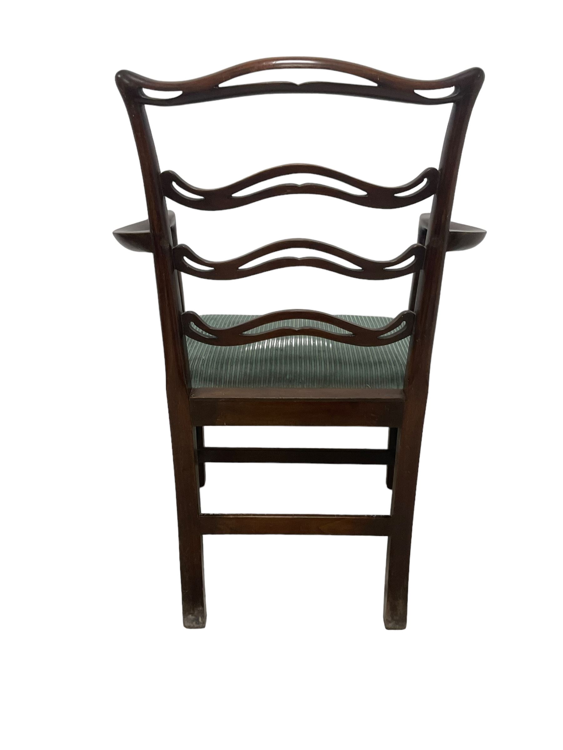 Set of twelve (10+2) Chippendale revival stained beech dining chairs, pierced waived ladder backs with over-stuffed over seats, on square moulded supports joined by stretchers