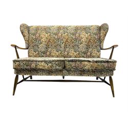 Lucian Ercolani for Ercol - mid-20th century beech and elm 'Windsor 203' two-seat sofa, wingback design upholstered in floral pattern over sprung seat and backrest, open curved arms, on splayed supports with stretchers (W133cm, D87cm, H90cm); matching easy chair (W70cm, D97cm, H82cm)