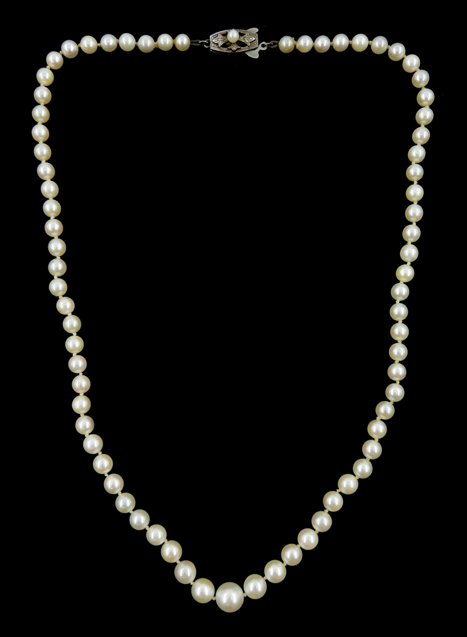 Mikimoto single strand graduating cultured pearl necklace, on original silver clasp, stamped, with guarantee and pouch