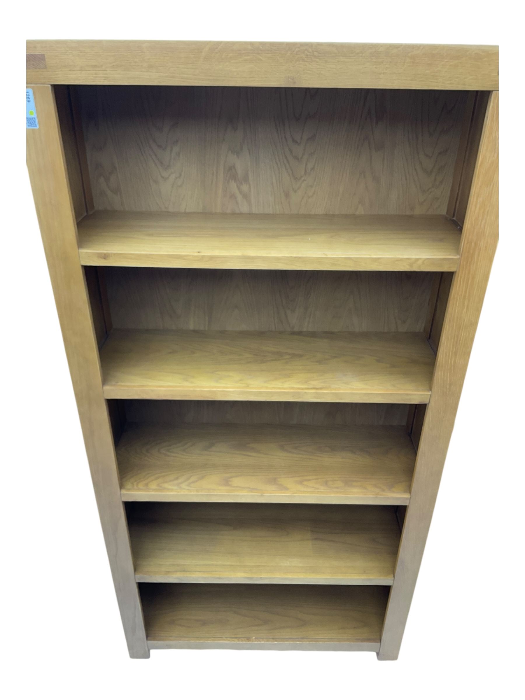 Light oak open bookcase fitted with four shelves 