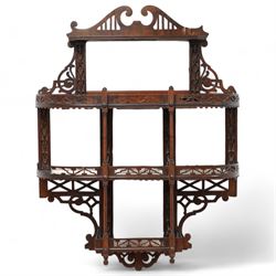 Early 20th century fretwork wall mirror shelf, swan neck pediment over four tiers and beve...