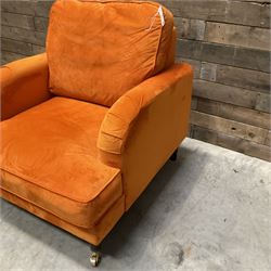 Armchair upholstered in orange velvet fabric