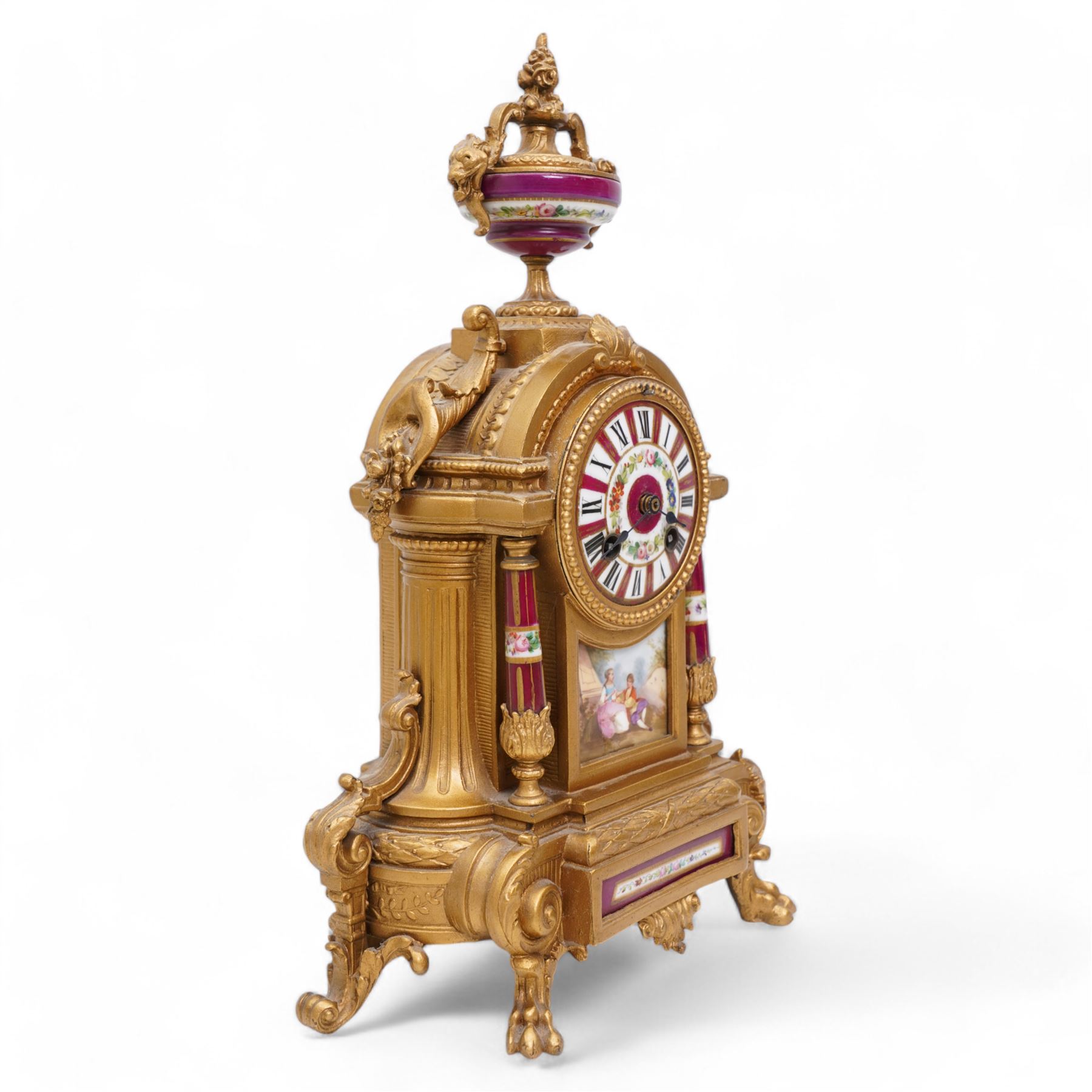 French - Late 19th century 8-day gilt metal and porcelain mounted clock c1880, the arched case above a plinth base on paw feet surmounted by an urn, porcelain dial with cartouche Roman numerals and steel spade hands, twin train rack striking movement, sounding the hours and half hours on a bell. With pendulum. 