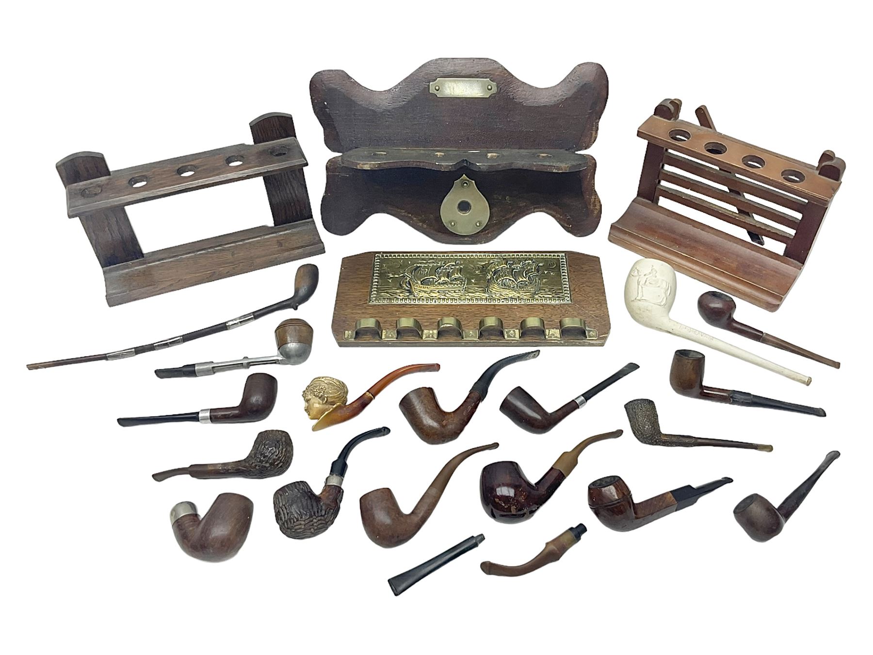 Collection of smoking pipes including Meerschaum pipe, carved as a female head, Briars and clay examples, etc and four pipe racks/stands