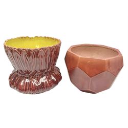 Two Bretby jardinieres, the first example with geometric hexagonal decoration in a red glaze, the second moulded as a flower head, in red glaze with yellow glaze to interior,  both with impressed marks beneath, tallest H25.5cm