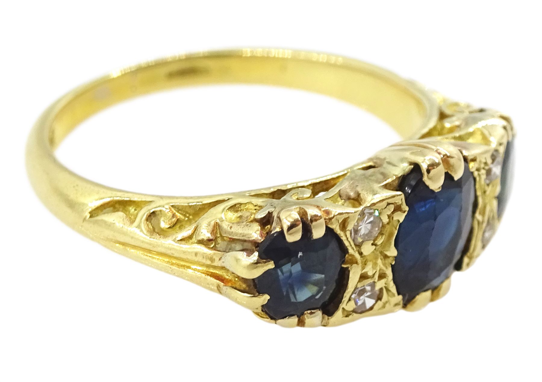 18ct gold three stone oval cut sapphire and four stone round brilliant cut diamond ring, stamped