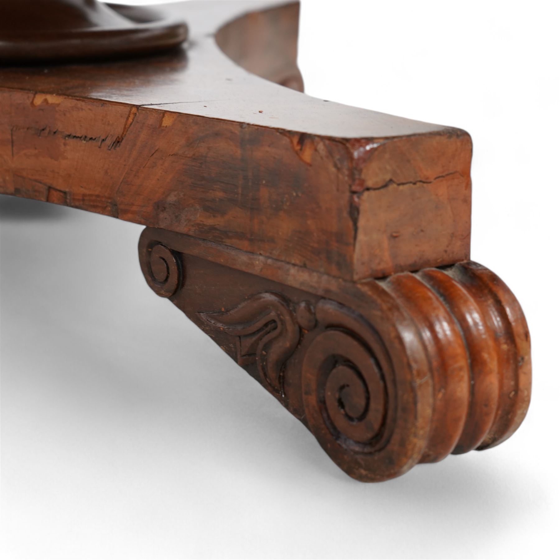 Victorian mahogany breakfast centre table, circular tilt-top with figured segmented veneers, tapering octagonal column on concaved triangular platform, scrolled carved feet 