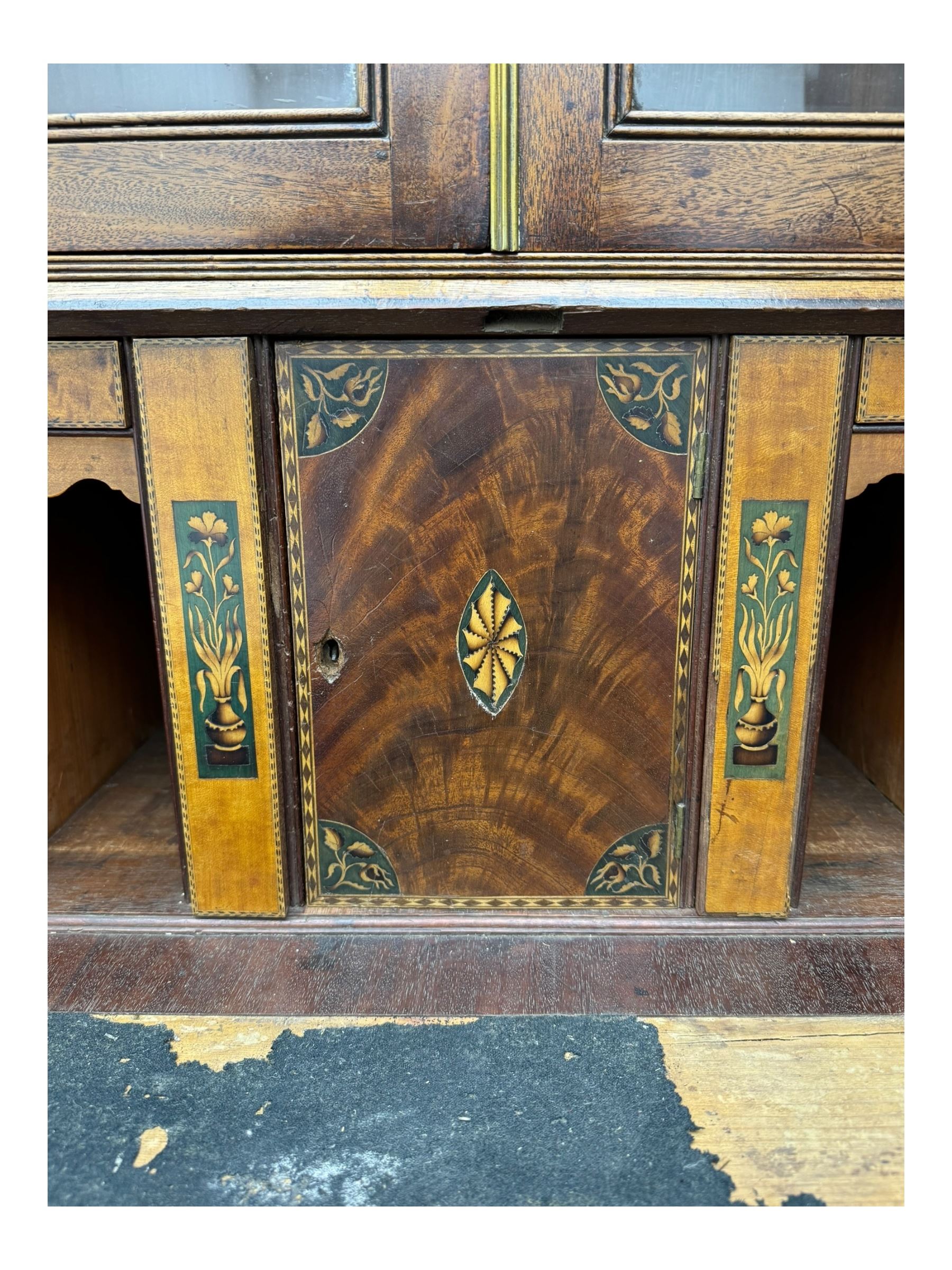 Early 19th century mahogany bureau bookcase, the projecting cornice over two Gothic-style astragal glazed doors enclosing two adjustable shelves, sloped hinged lid enclosing fitted interior and felt inset, four graduating drawers, on bracket feet