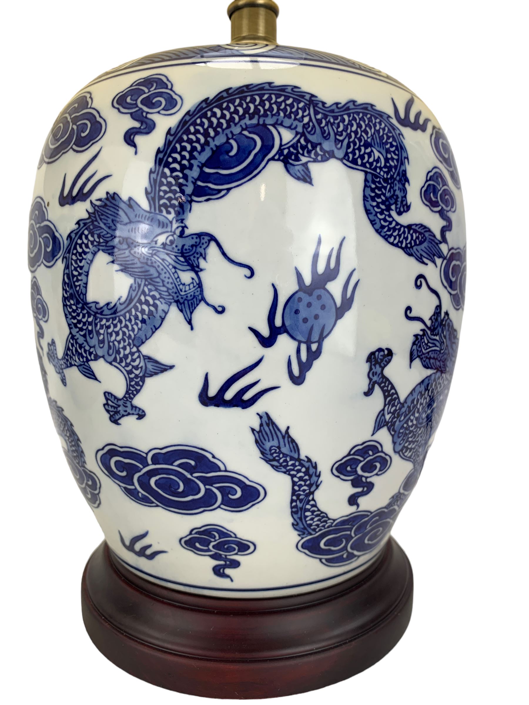 Pair of blue and white ovoid form table lamps, each decorated with dragons chasing the flaming pearl amidst clouds, raised upon circular hardwood bases, H28cm excluding fitting