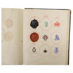 Victorian album of crests and monograms, including examples cut from envelopes and stamped into wax seals, with label to interior front cover reading 'Edward Law's Crest Collection Album 243' 