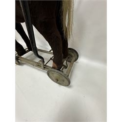 1920s/30s Panurge Pets push-a-long horse, with brown mohair body and white face, horse hair mane and tail and leather hooves, mounted upon a metal with rubber and metal wheels, including handle H71cm