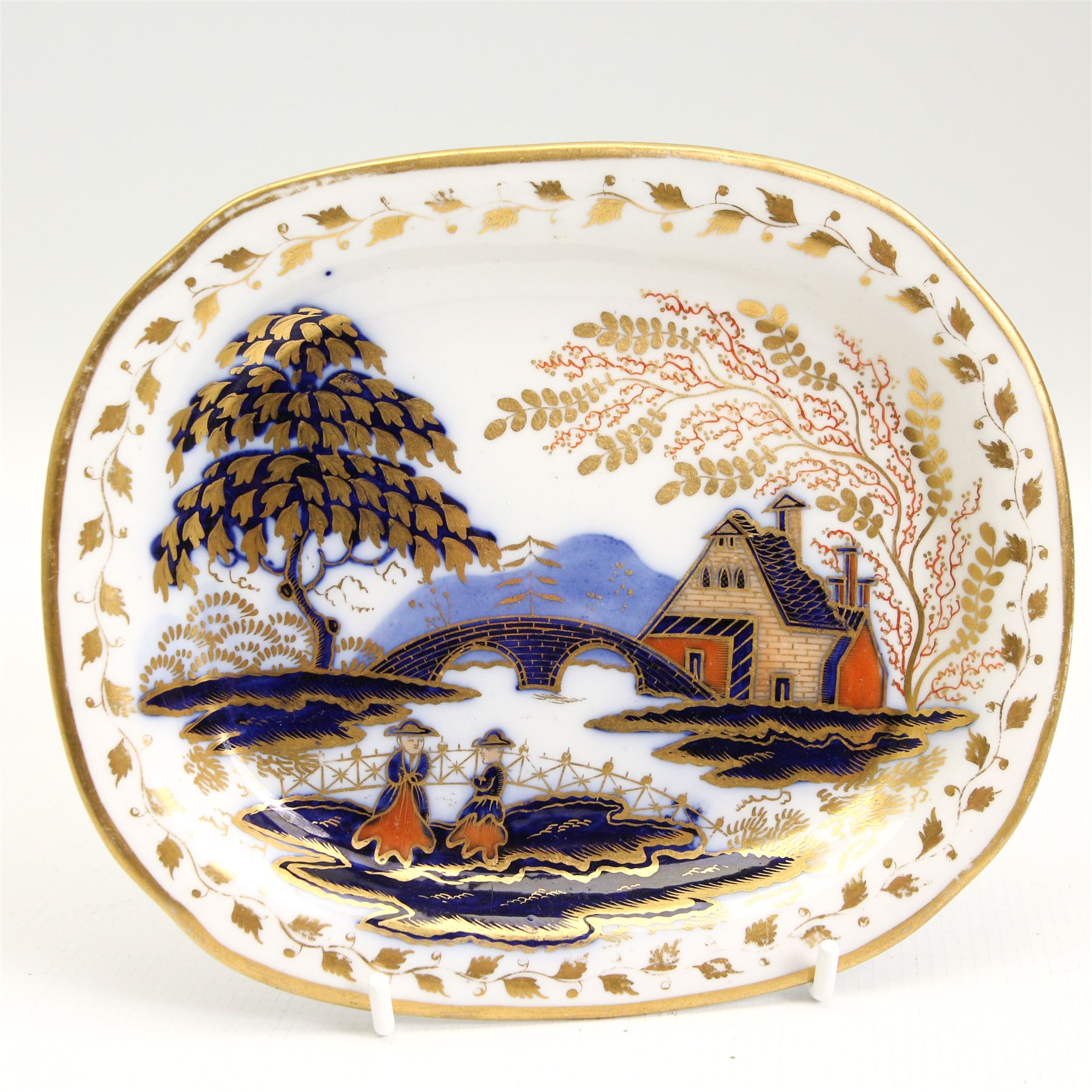 19th century Davenport cabinet plate, centrally painted with a view of Crummock & Buttermere, within a green border, titled and numbered 1247 verso, D25.5cm, Davenport Longport cabinet plate, 19th century rococo influence inkwell, porcelain bowl retailed by T.Goode & Co., together with a Newhall teapot stand, decorated in the imari pallette, patten no. 1154 L18.5cm (5)