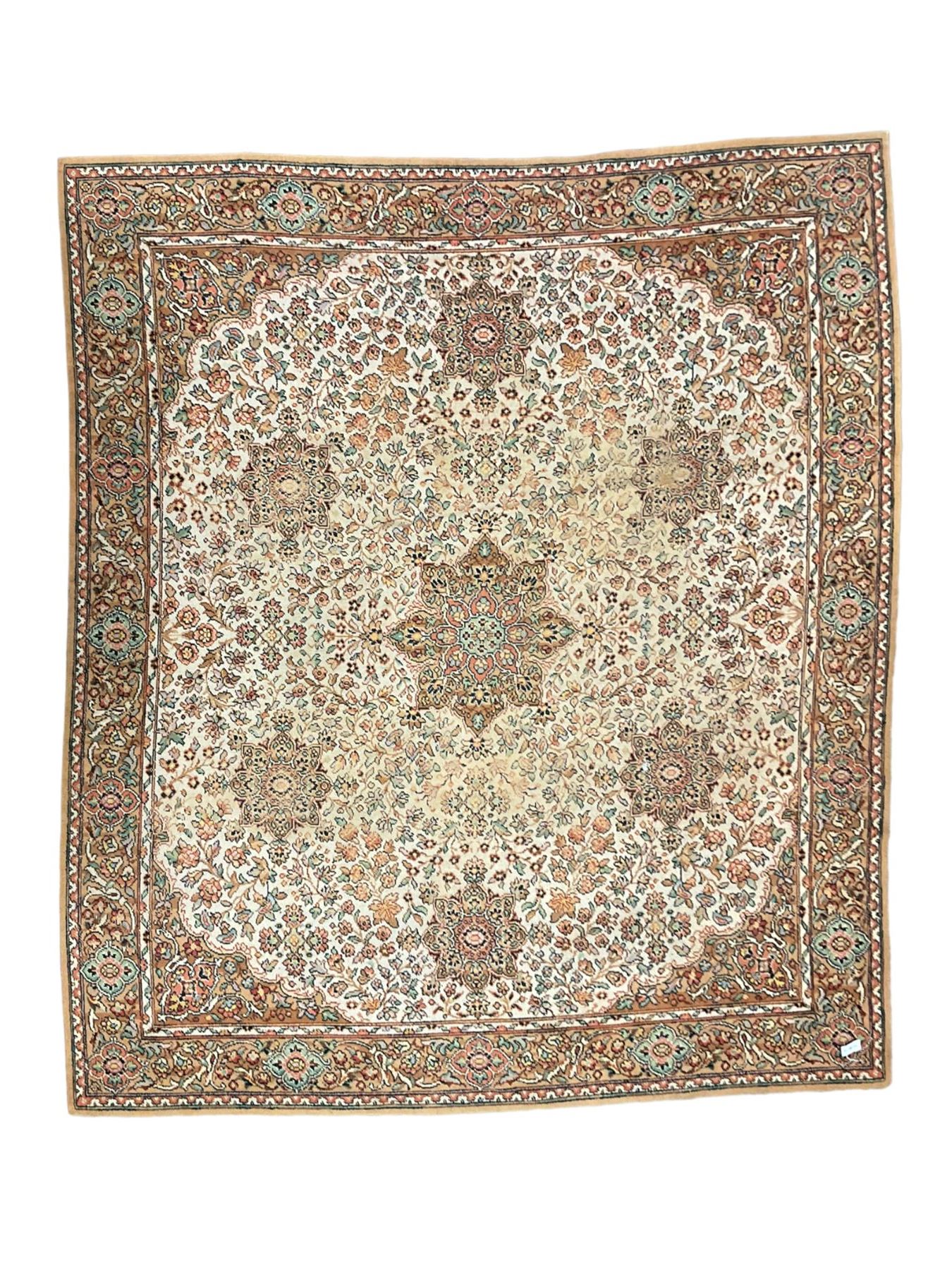 Large Persian design carpet, overall floral design, the field decorated with large rosette motifs surrounded by trailing foliate motifs, the border decorated with trailing branch and stylised plant motifs