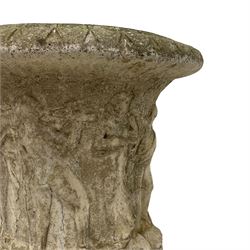 Cast stone Campana shaped urn, decorated with festival scenes over gadrooned underbelly, circular foot on square base