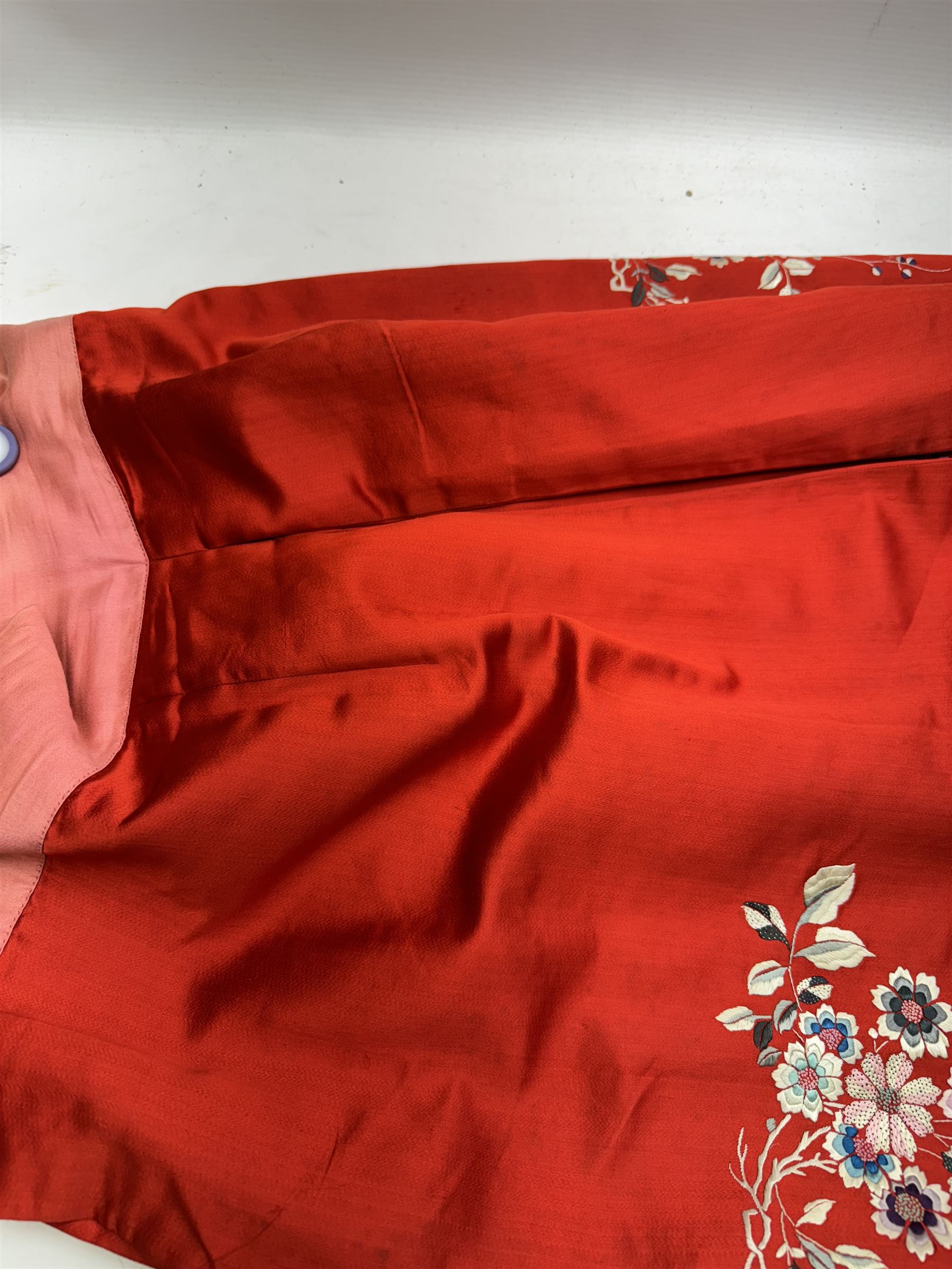 Early 20th century Chinese Han silk skirt, embroidered with flowers and butterflies, on a red ground, purchased from Liberty, London