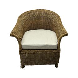 Rattan armchair and ottoman set, pair of armchairs featuring rounded backrests with wide armrests, woven wicker frame with weaving and upholstered seat cushions in off-white fabric with flowing floral pattern (W83 D80 H78cm); matching round ottoman with upholstered cushion on square wooden feet (W65 D65 H37cm)