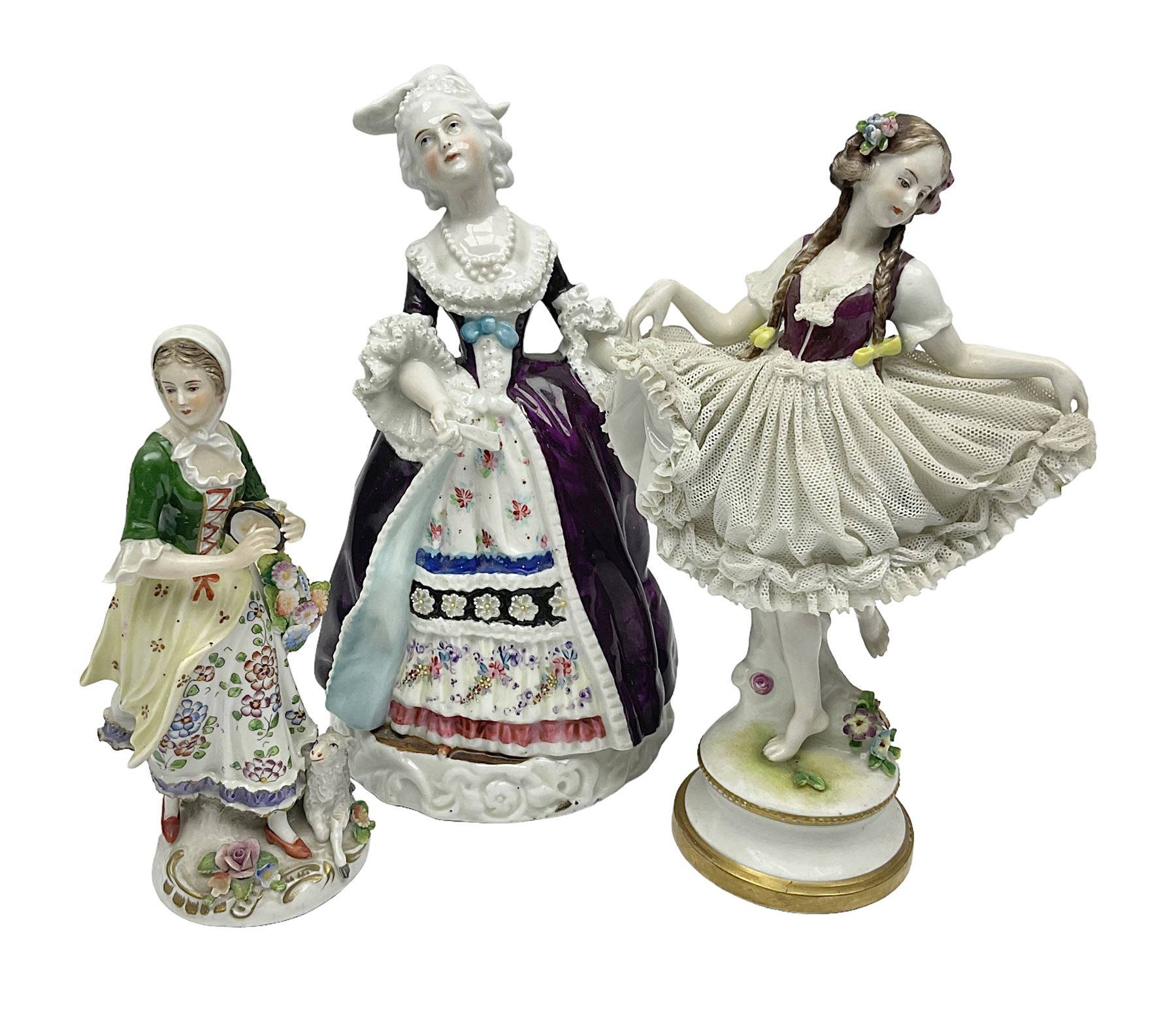 Continental figure modelled as a girl holding her lace skirt upon a circular base, together with two other figures, largest H22cm