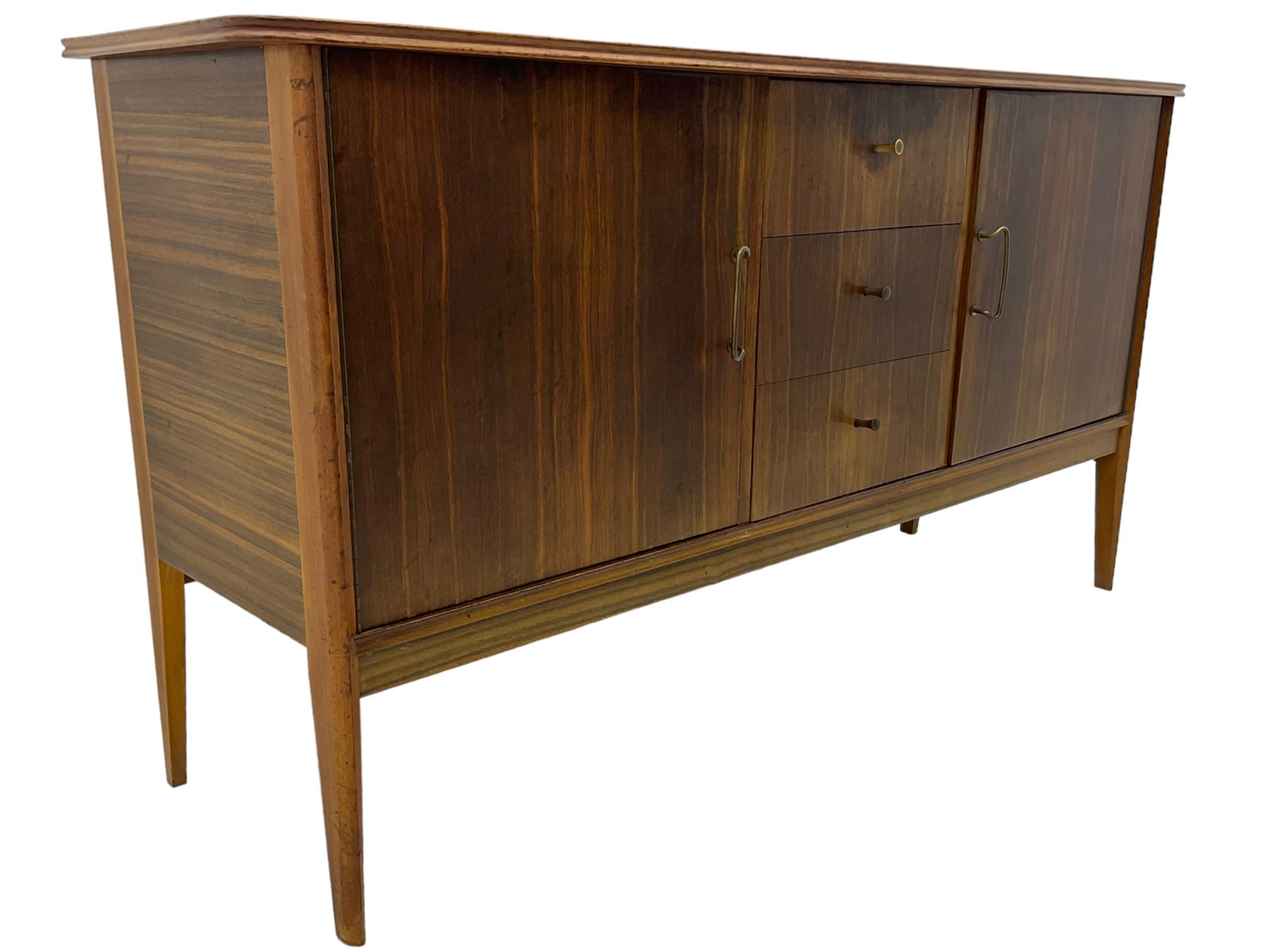 Mid 20th century teak sideboard, rectangular top with rounded corners over three central drawers, flanked by two cupboard doors enclosing shelves, raised on tapered supports