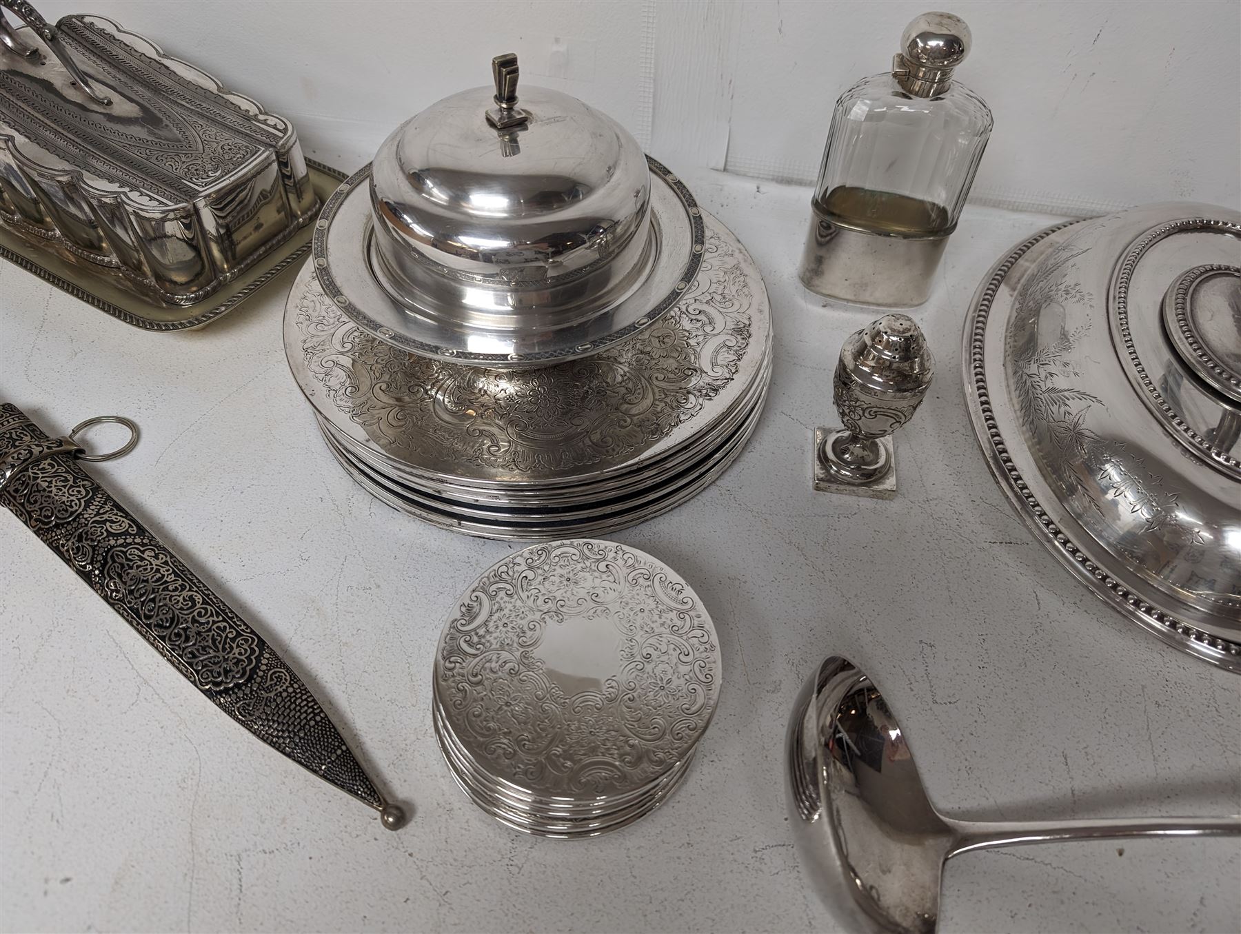 Glass hip flask, with silver cap/collar and plated cup and a silver topped pepper shaker, together with silver plated items including place mats, coasters, serving dishes, etc