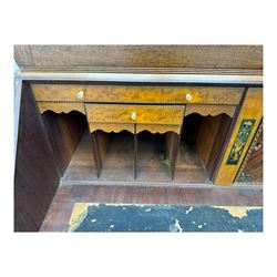 Early 19th century mahogany bureau bookcase, the projecting cornice over two Gothic-style astragal glazed doors enclosing two adjustable shelves, sloped hinged lid enclosing fitted interior and felt inset, four graduating drawers, on bracket feet