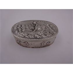 Late 19th century German Hanau silver box, of oval form, embossed throughout with putti in various scenes including riding a dog, playing instruments, pulling a cart and dancing, opening to reveal a gilt interior, with Hanau marks for B Neresheimer & Sohne, W9cm, H3cm