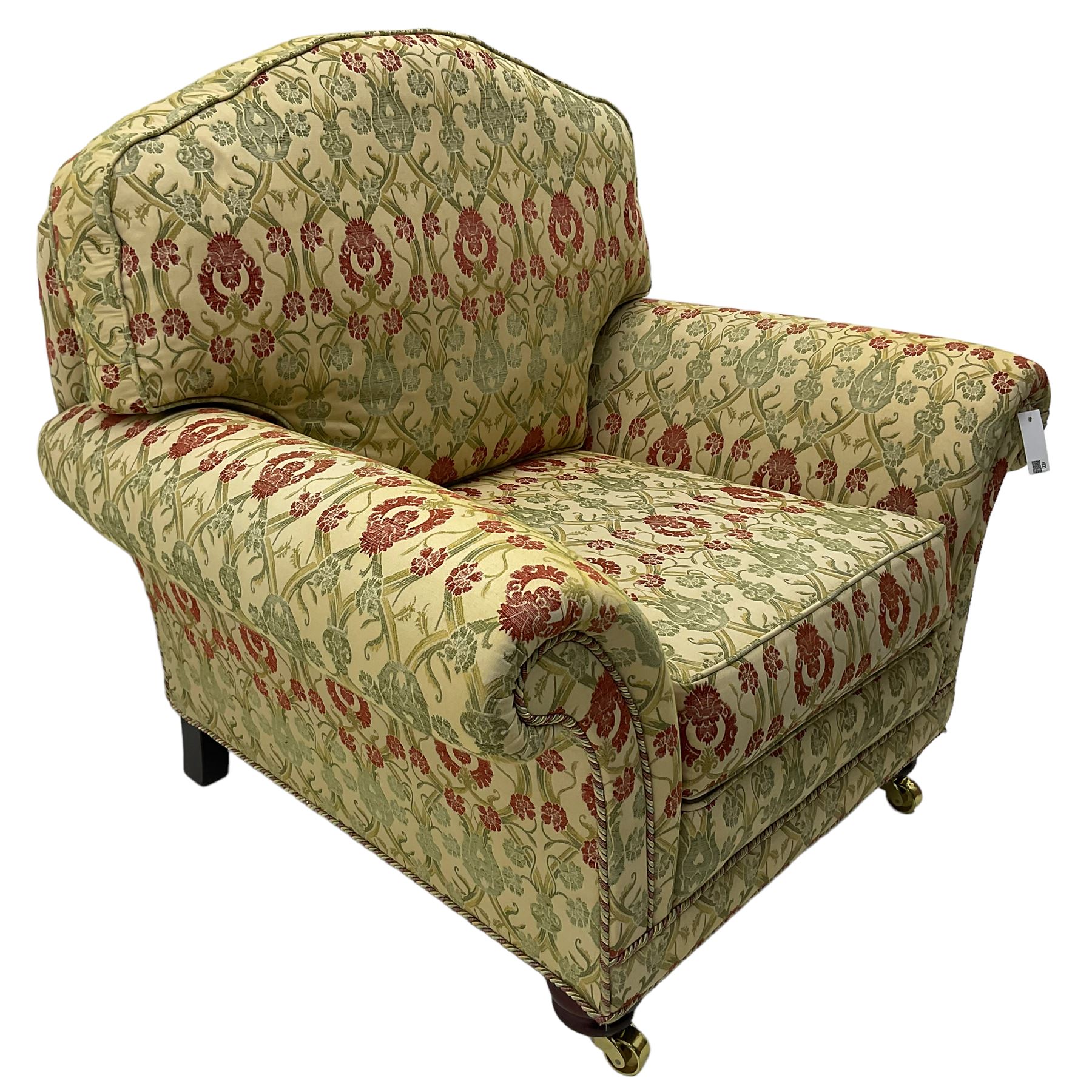 Traditional design two seat sofa, high back with scrolled arms, upholstered in beige fabric with red and green damask motifs, on castor supports (L178cm, D100cm, H89cm); matching armchair (L109cm, D89cm, H89cm)