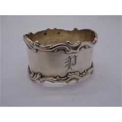 Set of six Edwardian silver napkin rings, of oval form with scroll detailed rims and engraved initials, hallmarked Harrison Brothers & Howson, Sheffield 1906, contained within a fitted case with blue silk and velvet lined interior, approximate silver weight 5.46 ozt (170 grams)