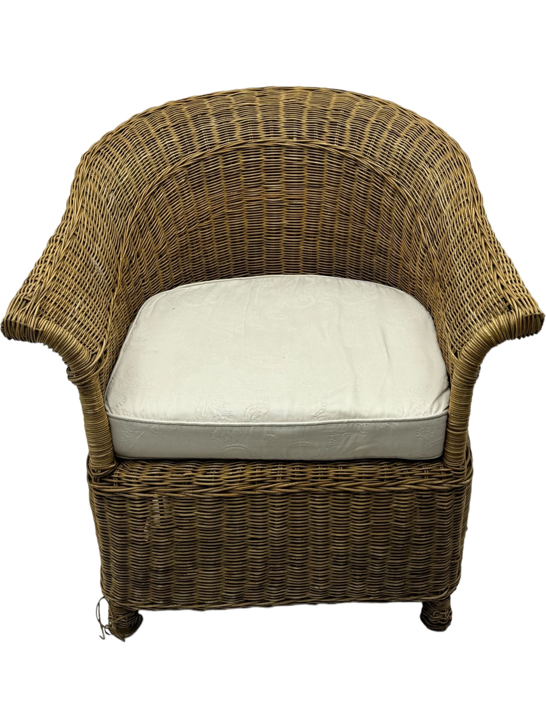 Rattan armchair and ottoman set, pair of armchairs featuring rounded backrests with wide armrests, woven wicker frame with weaving and upholstered seat cushions in off-white fabric with flowing floral pattern (W83 D80 H78cm); matching round ottoman with upholstered cushion on square wooden feet (W65 D65 H37cm)