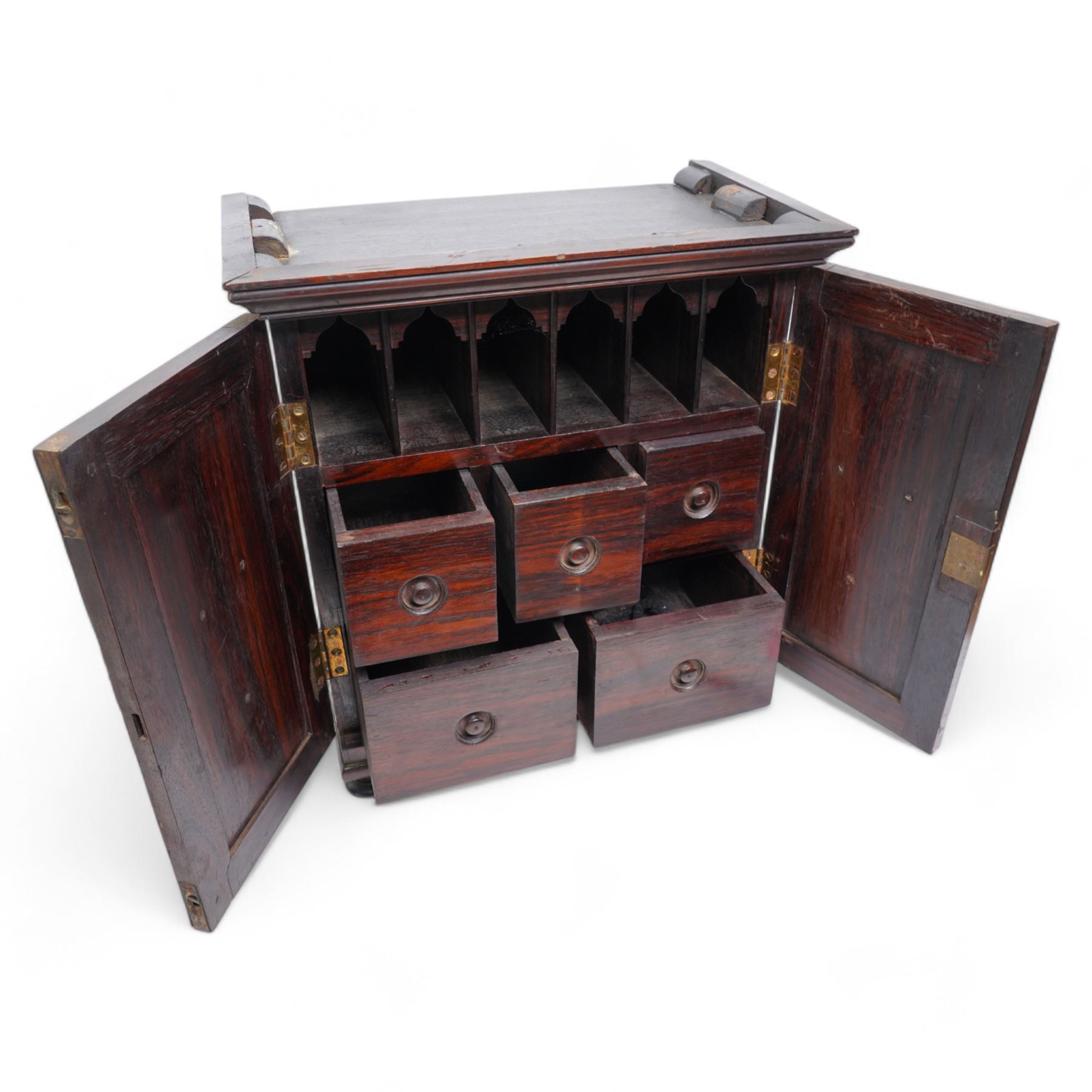 19th century rosewood spice cabinet, moulded cornice over two panelled doors decorated with fruiting foliage carved mounts, the interior fitted with a combination of small drawers, on turned feet