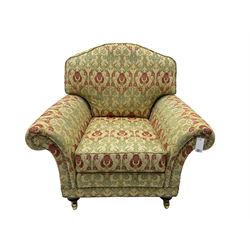 Traditional design two seat sofa, high back with scrolled arms, upholstered in beige fabric with red and green damask motifs, on castor supports (L178cm, D100cm, H89cm); matching armchair (L109cm, D89cm, H89cm)