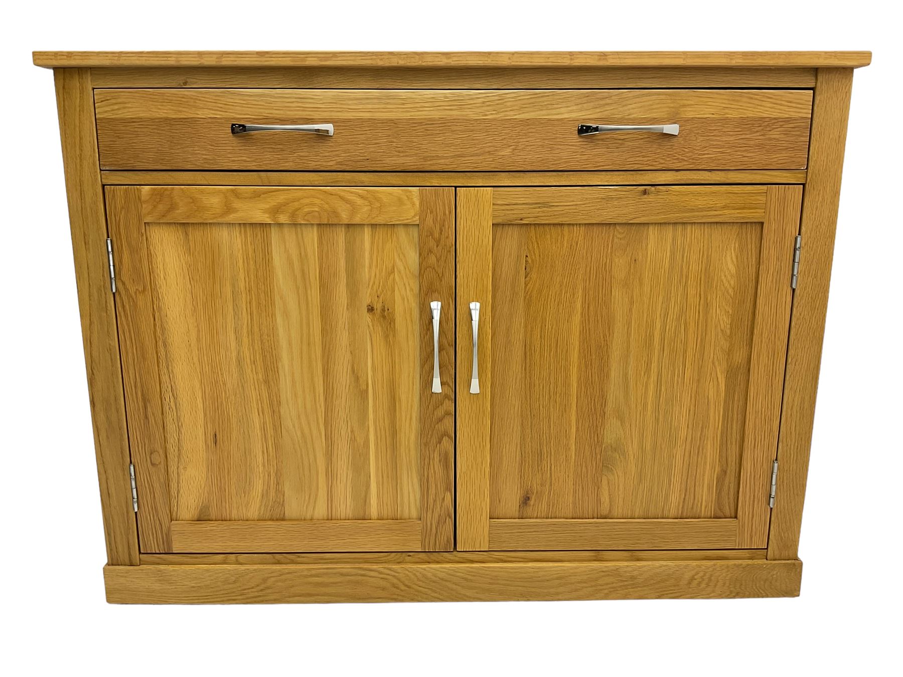 Contemporary light oak sideboard desk, rectangular top with full length drawer, hinged front panel revealing pull-out keyboard tray, over two panelled doors enclosing an assortment of shelves and compartments with cable management holes, on plinth base