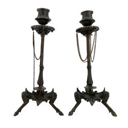 Pair of 19th century French patinated bronze candlesticks in the manner of Ferdinand Barbedienne, the gadrooned sconces hung with chains, reeded columns on tripod supports with hoof feet, H28cm 