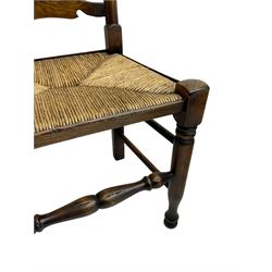 Matched set of eight (7+1) oak ladder back dining chairs, waved ladder back over rush seats, on turned supports joined by turned stretchers