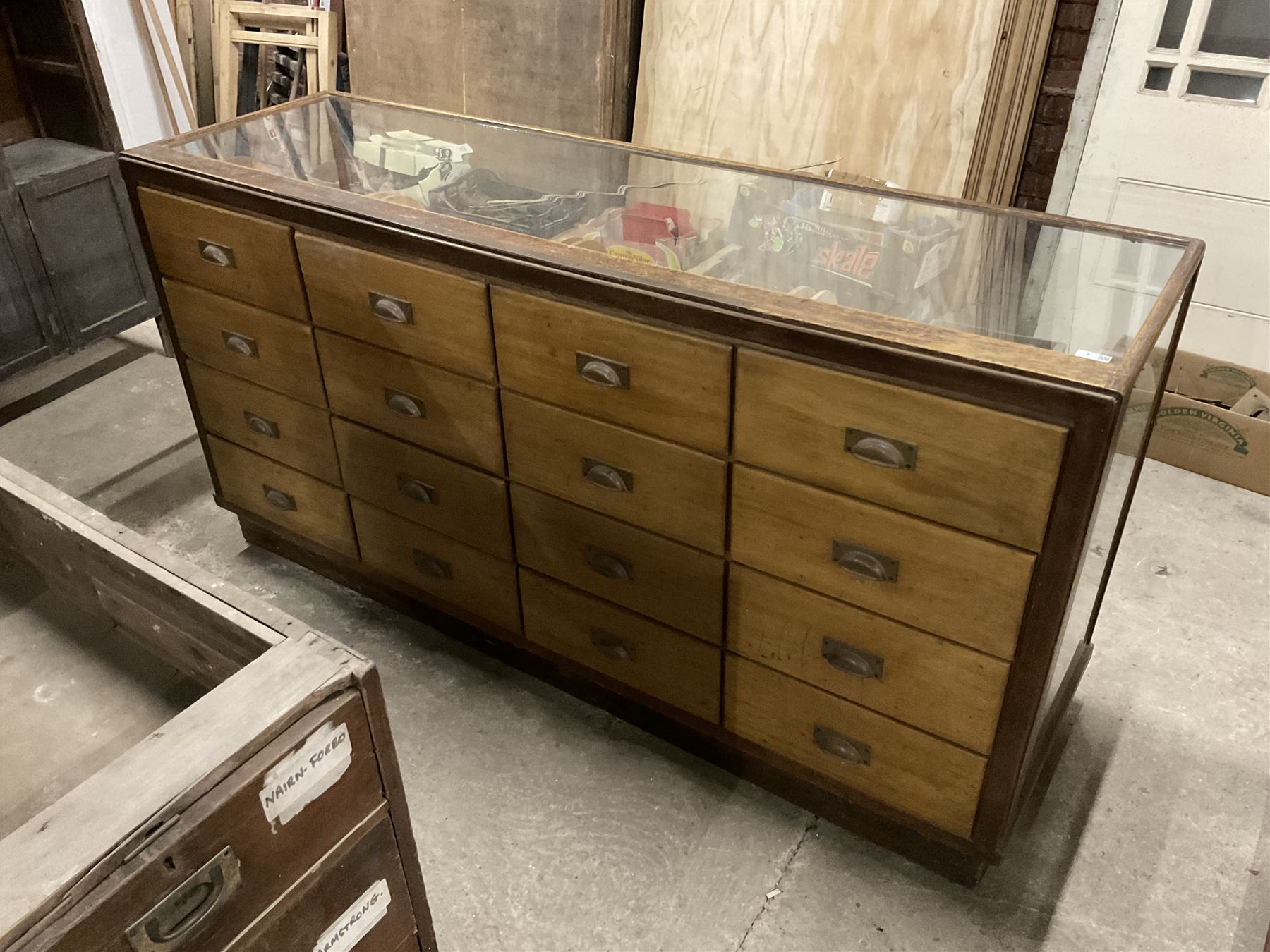 20th century oak and glazed haberdashery shop’s cabinet, glass front and sides, fitted with sixteen graduating drawers  - THIS LOT IS TO BE COLLECTED BY APPOINTMENT FROM THE OLD BUFFER DEPOT, MELBOURNE PLACE, SOWERBY, THIRSK, YO7 1QY