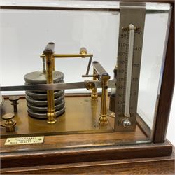 Edwardian oak cased barograph labelled 'Benn Franks Optician Hull Hanley etc' with lacquered brass mechanism, six bellow aneroid tower, silvered thermometer, clockwork drum and fitted ink bottle, lift-off cover with five bevelled glass panels on stepped base with chart drawer and bracket feet W37cm