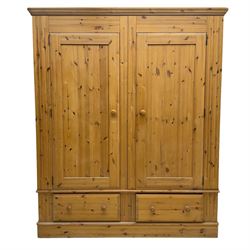 Pine double wardrobe, enclosed by panelled doors, two drawers to base